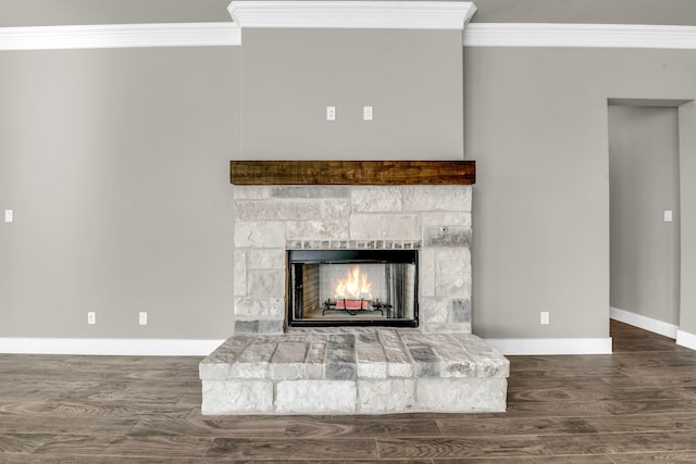 room details with a stone fireplace, hardwood / wood-style floors, and ornamental molding