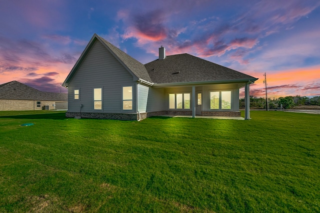 back house at dusk with a yard