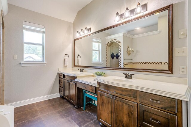 bathroom featuring vanity, vaulted ceiling, and tile patterned floors