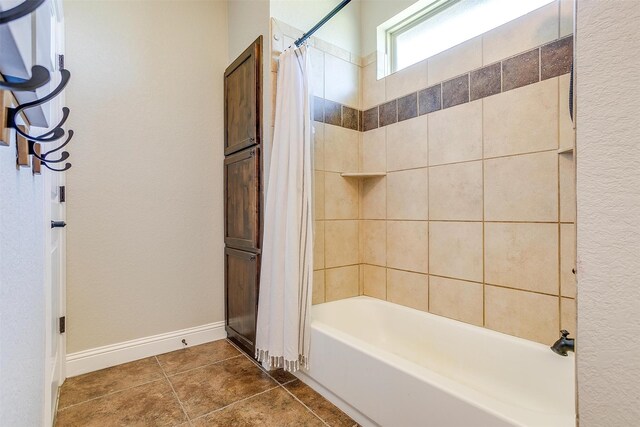 bathroom with shower / tub combo with curtain and tile patterned floors