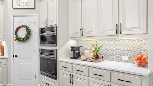 kitchen with decorative backsplash and white cabinetry