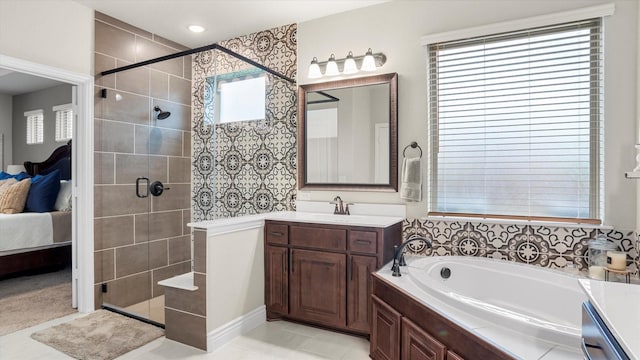 bathroom featuring separate shower and tub, tile patterned flooring, vanity, and a healthy amount of sunlight