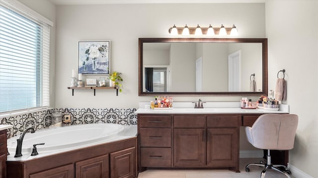 bathroom featuring tile patterned flooring, vanity, and a tub to relax in