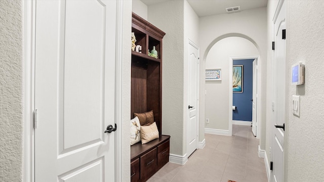 hall featuring light tile patterned flooring