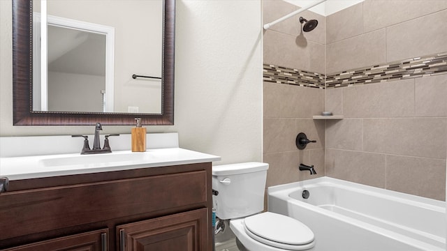 full bathroom with toilet, vanity, and tiled shower / bath