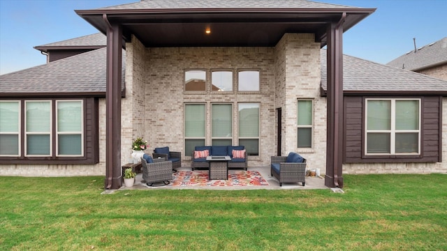 rear view of property with a lawn, a patio area, and an outdoor hangout area