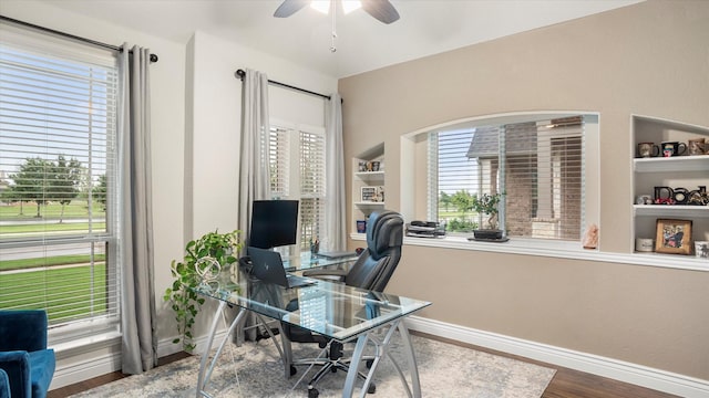 home office with wood-type flooring and ceiling fan