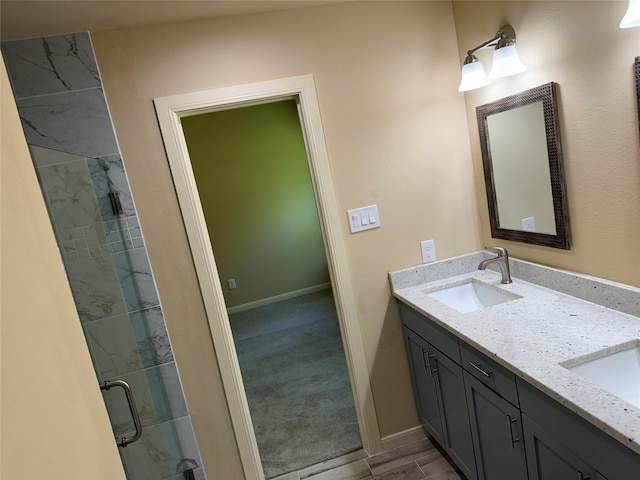 bathroom with double vanity, an enclosed shower, and tile floors