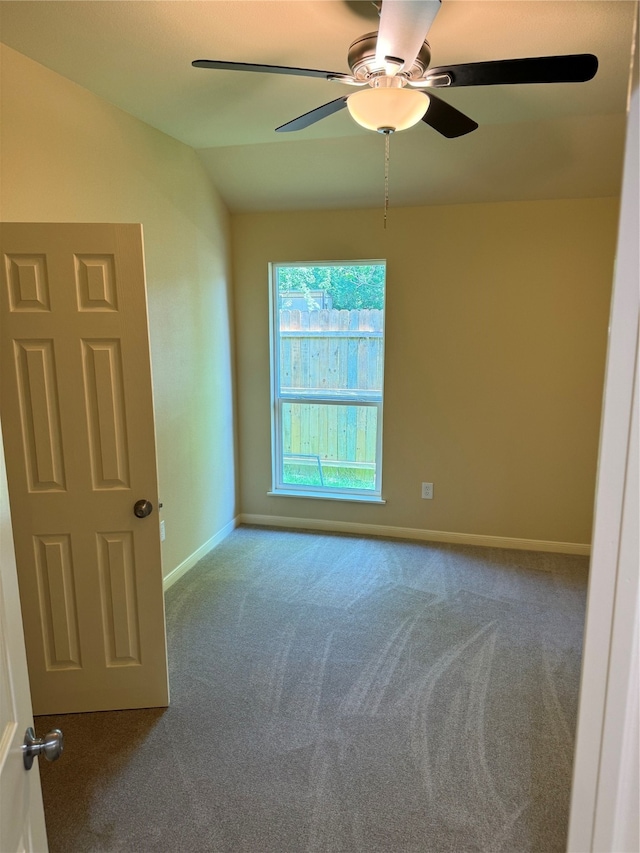 spare room featuring lofted ceiling, carpet floors, and ceiling fan