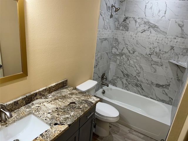 full bathroom with tiled shower / bath, wood-type flooring, toilet, and vanity