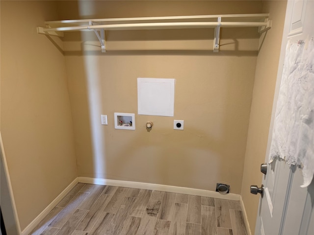 clothes washing area featuring hookup for a gas dryer, hookup for a washing machine, electric dryer hookup, and hardwood / wood-style floors