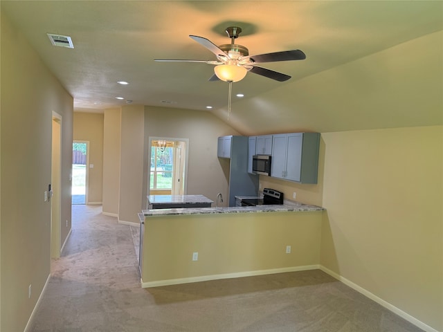 kitchen with light carpet, kitchen peninsula, ceiling fan, and range