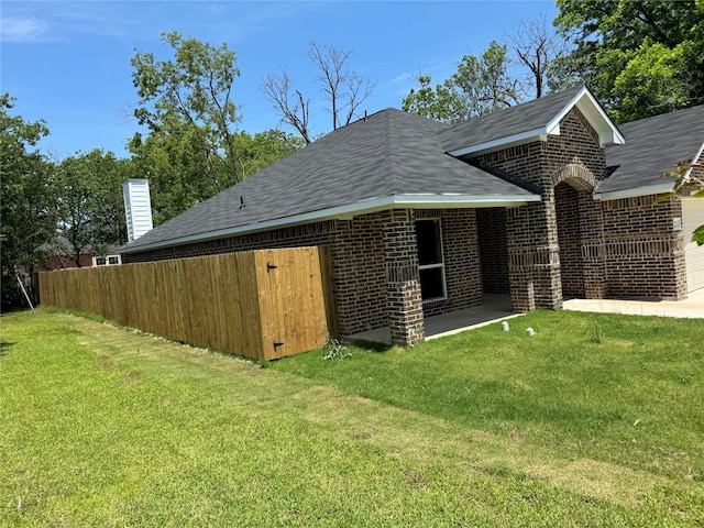 back of property with a patio and a yard