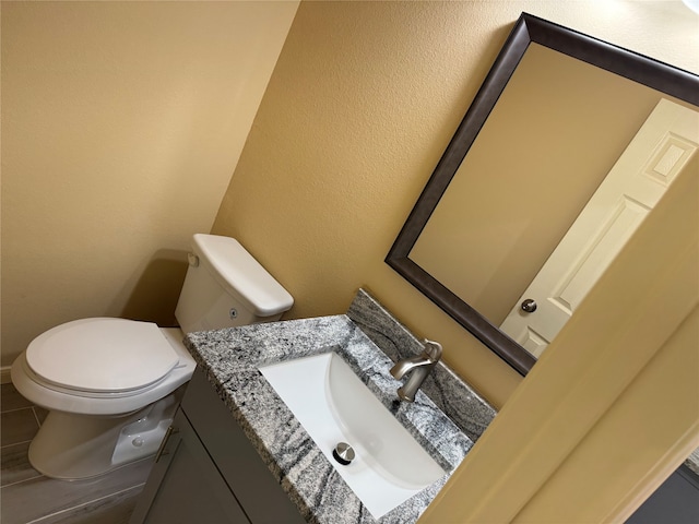 bathroom featuring tile flooring, toilet, and large vanity