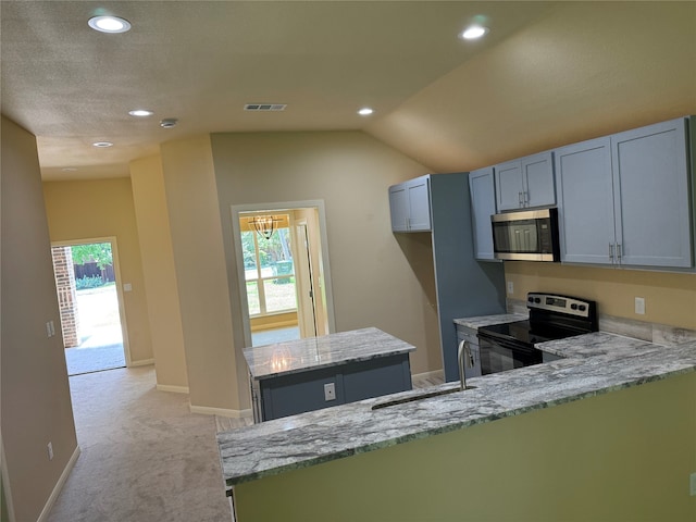 kitchen featuring appliances with stainless steel finishes, light carpet, kitchen peninsula, light stone counters, and sink