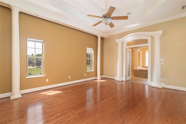 spare room featuring decorative columns and hardwood / wood-style flooring