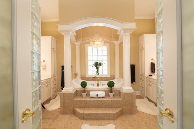 bathroom with tile patterned floors, crown molding, tiled bath, and ornate columns