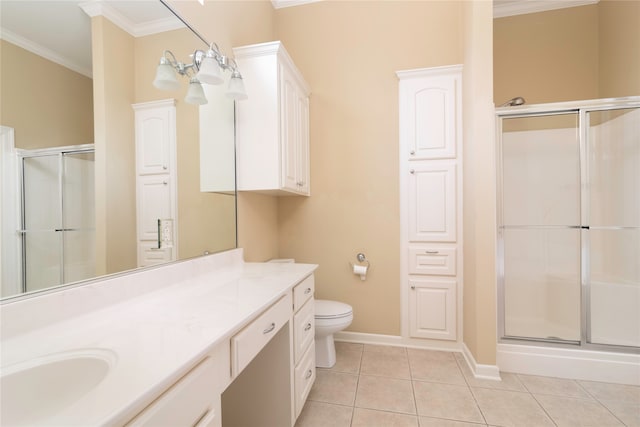 bathroom featuring ornamental molding, tile patterned flooring, vanity, toilet, and a shower with door