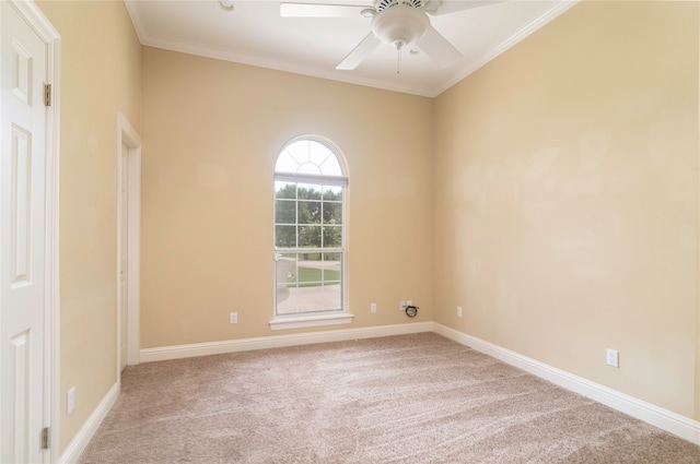 unfurnished room with ceiling fan, crown molding, and light carpet