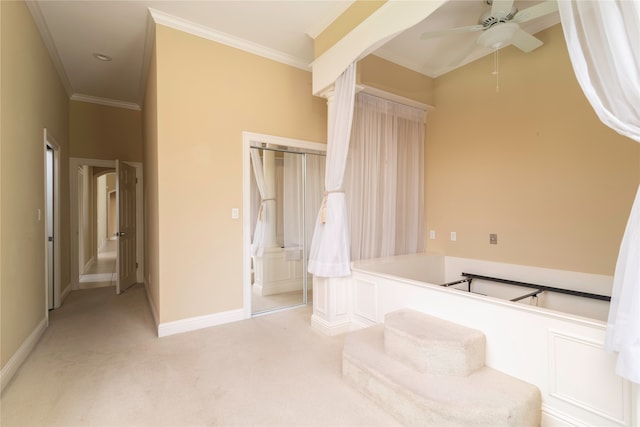 carpeted bedroom with ceiling fan and crown molding