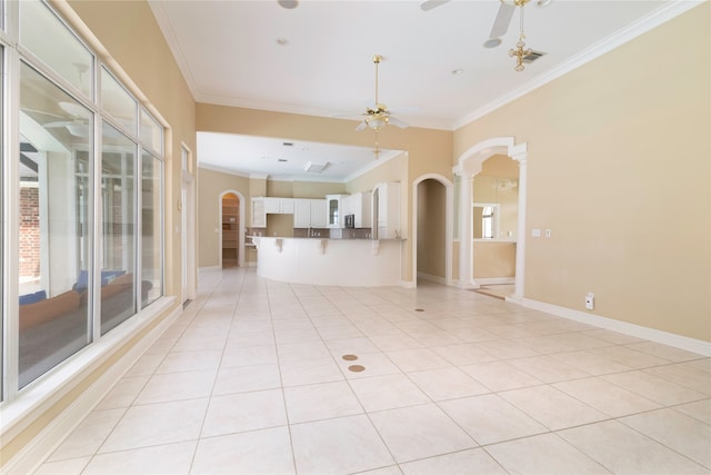 empty room with ceiling fan, ornamental molding, and light tile patterned floors