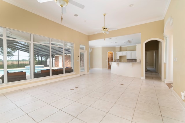 spare room with ceiling fan, light tile patterned floors, and ornamental molding