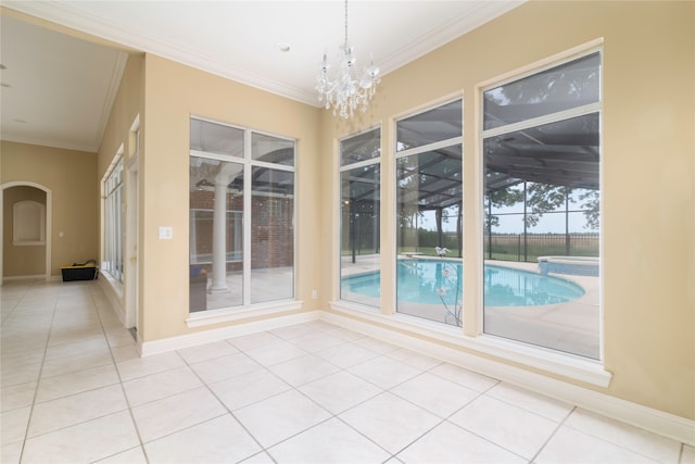 unfurnished room featuring a notable chandelier, light tile patterned flooring, and ornamental molding