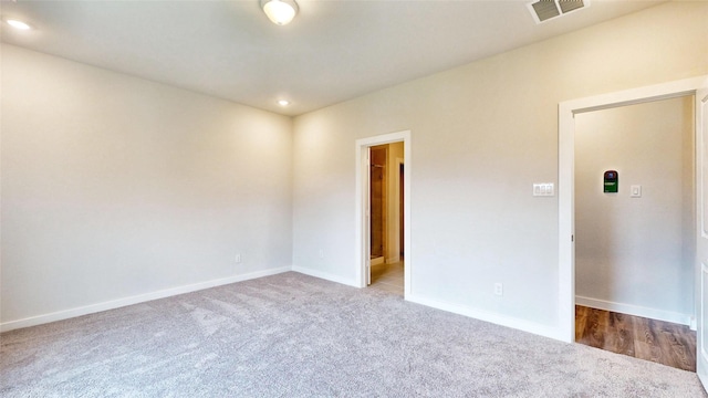 carpeted empty room with recessed lighting, visible vents, and baseboards