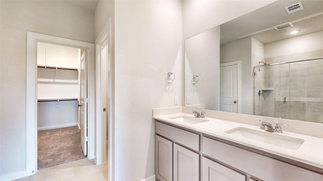 bathroom with vanity and a shower with shower door