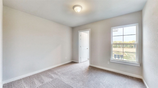 unfurnished room with light carpet