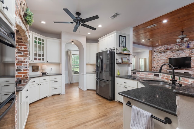 kitchen with sink, white cabinets, refrigerator with ice dispenser, and light wood-type flooring