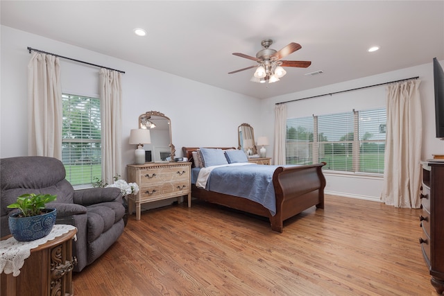 bedroom with ceiling fan and hardwood / wood-style flooring