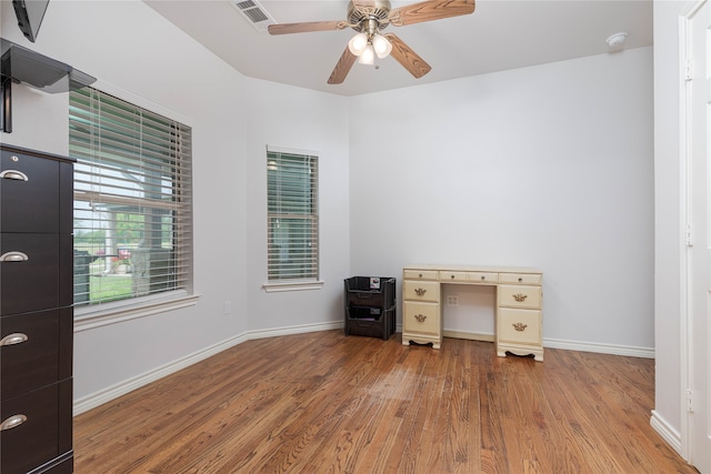 unfurnished office with ceiling fan and hardwood / wood-style flooring