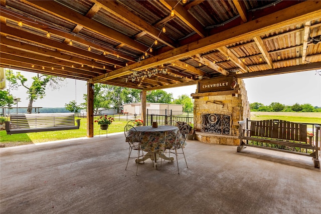 view of terrace featuring an outdoor stone fireplace