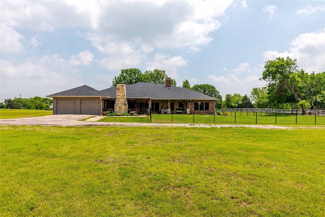 view of front of house featuring a garage and a front yard