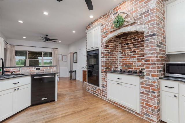 kitchen featuring ceiling fan, light wood-type flooring, black appliances, sink, and white cabinetry