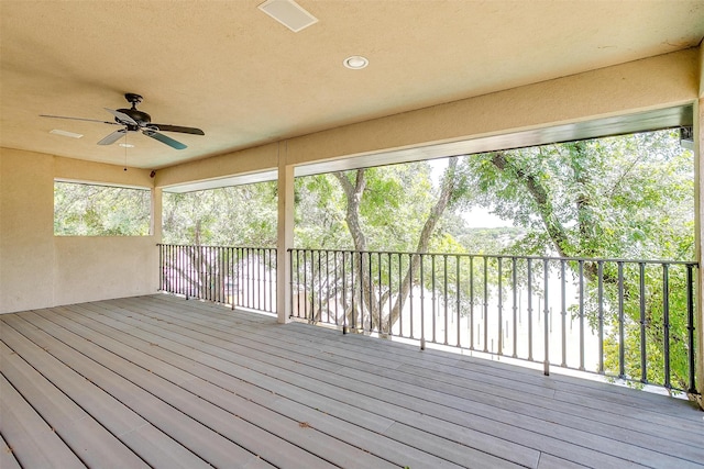 wooden deck featuring ceiling fan