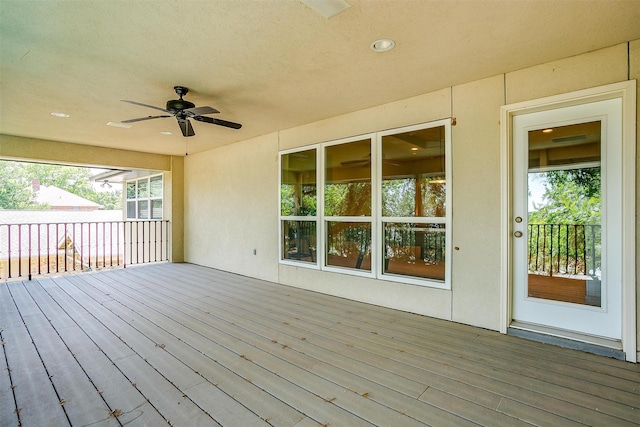 wooden terrace featuring ceiling fan