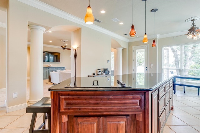 kitchen with ceiling fan, decorative columns, decorative light fixtures, and light tile floors