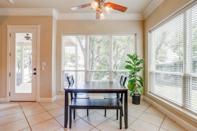 tiled dining space featuring ceiling fan and ornamental molding