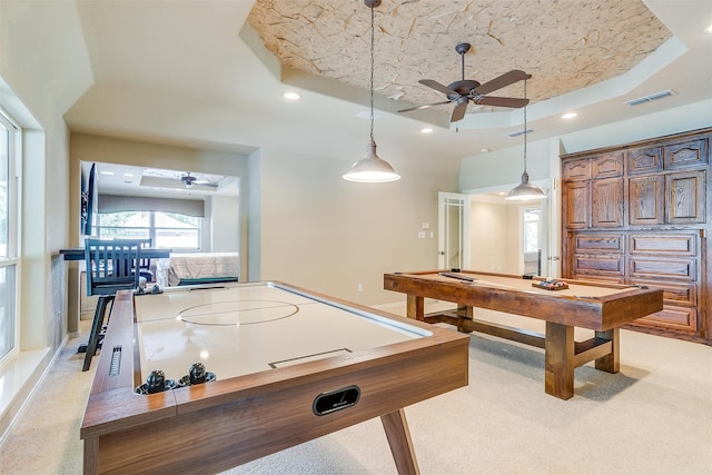 recreation room with a textured ceiling, a tray ceiling, billiards, ceiling fan, and light colored carpet