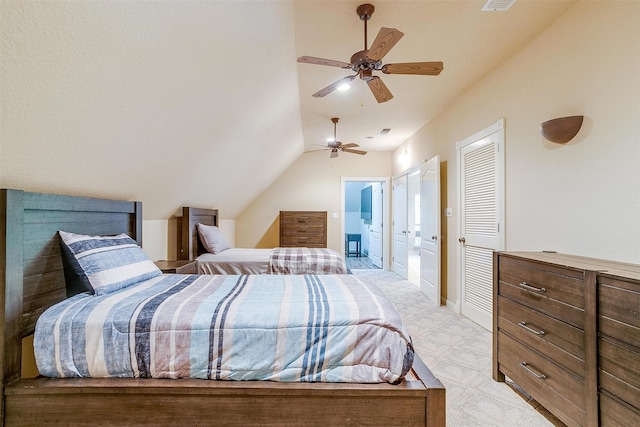 bedroom with light carpet, ensuite bath, ceiling fan, and lofted ceiling