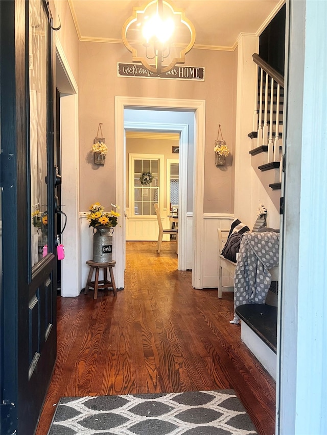 hall with hardwood / wood-style floors and crown molding