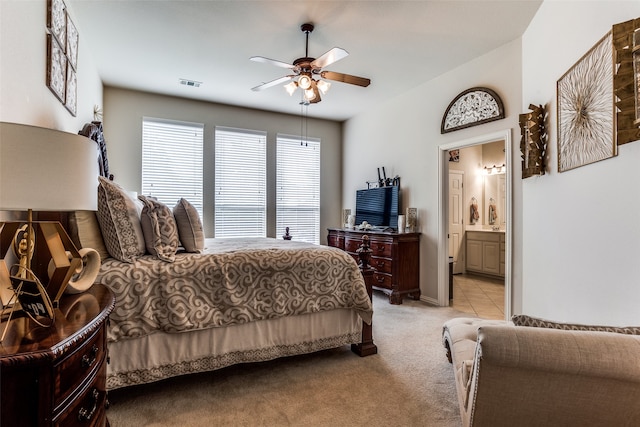 carpeted bedroom featuring ensuite bathroom and ceiling fan