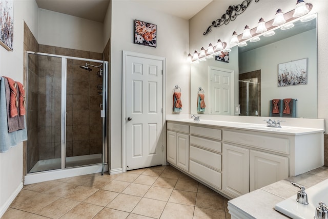 bathroom with tile patterned floors, vanity, and a shower with shower door