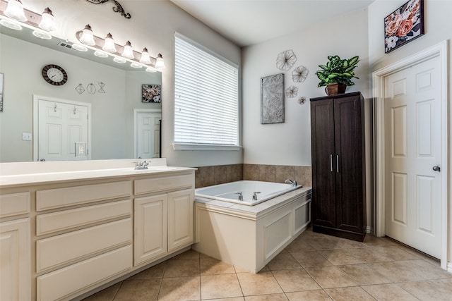 bathroom with a bathing tub, tile patterned flooring, and vanity