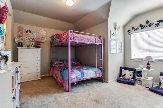 carpeted bedroom with vaulted ceiling