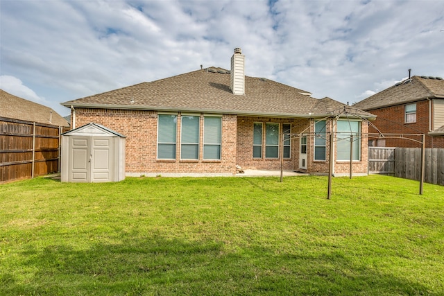 back of property featuring a lawn and a storage shed