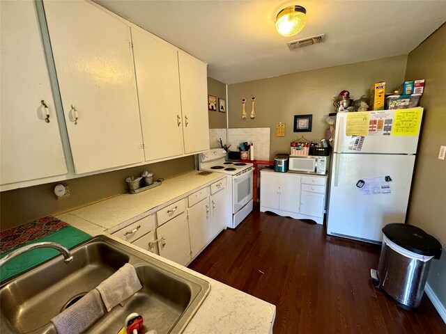 kitchen with sink, dark hardwood / wood-style flooring, white appliances, and white cabinetry