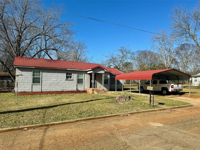 ranch-style house featuring a front yard and a carport